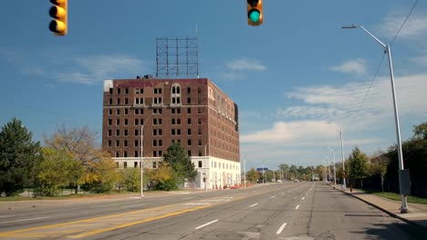 CLOSE-UP-Incomplete-and-abandoned-block-of-flats-by-the-roadside-in-Detroit,-USA