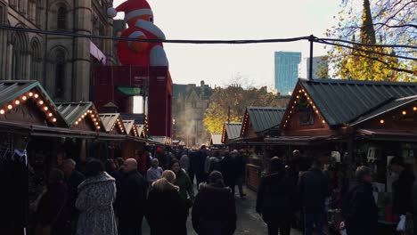 MANCHESTER,UK---DECEMBER-16,-2016.-Shot-of-shoppers-at-the-Christmas-market-in-front-of-the-Manchester-Town-Hall-on-Albert-Square.-December-16,-2016