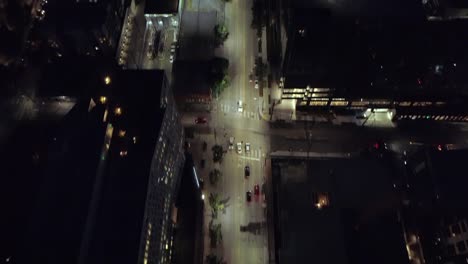 Epic-City-Aerial-at-Night-Panning-Lit-Street-to-Skyline-Skyscraper-Building-Lights