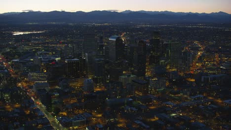 Aerial-view-of-Denver-at-night-with-Rocky-Mountains-in-background