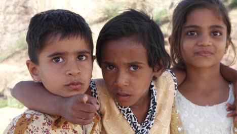 Indian-children-portrait-happy-and-excited,-playing-and-making-merry-in-sand-area-in-Rajasthan-state-of-India