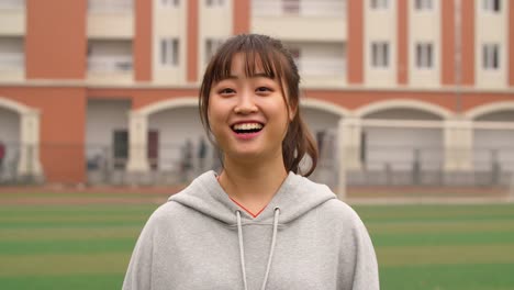 Portrait-of-young-asian-girl-smile-at-camera-in-campus