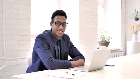 Smiling-Businessman-at-Work-Looking-at-Camera