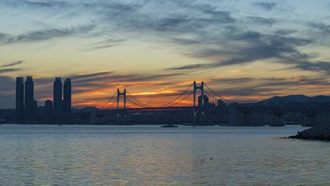 Timelapse-of-Gwangan-Bridge-and-Haeundae-at-Sunset,-Busan-City,-South-Korea.Timelapse-4k