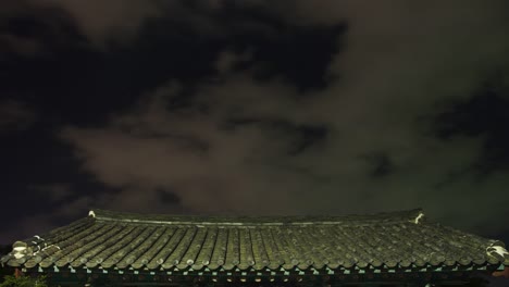 Gyeongju,-Korea-Ancient-house-roof-scene-at-night-in-moving-clouds