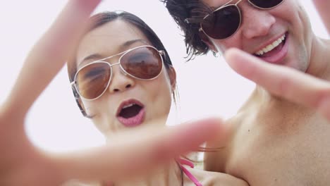 Portrait-Asian-Chinese-young-couple-sunglasses-filming-selfie