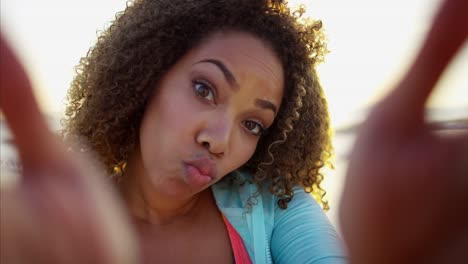 Portrait-of-African-American-female-relaxing-on-beach