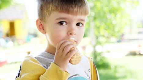 A-little-boy-of-three-years-is-eating-ice-cream-in-a-waffle-cup