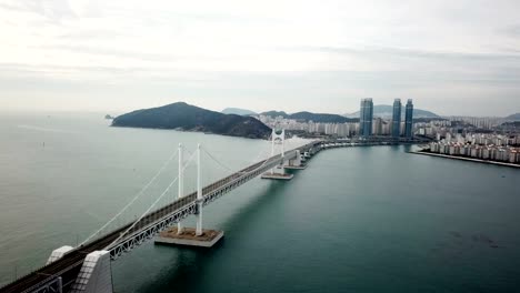 Gwangan-Bridge-and-Haeundae-aerial-view-at-Sunrise,-Busan,-South-Korea.