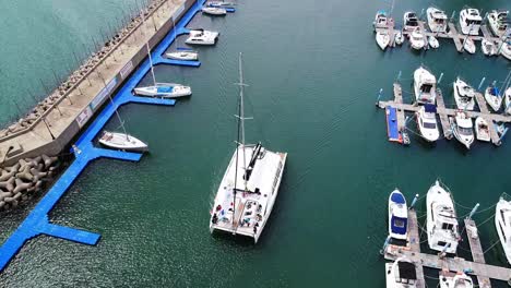 Aerial-shot-of-a-yacht-going-out-to-sea-in-Busan-Haeundae-Sea.