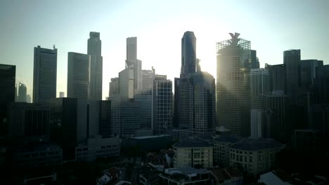Rising-and-forward-motion.-Beautiful-morning-drone-footage-of-Singapore-urban-skyline,-shop-houses-at-Chinatown-and-skyscrapers-at-central-business-district.