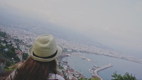 Young-woman-opening-arms-with-a-city-view