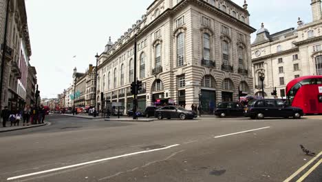 red-double-decker-bus-passing-by-Piccadilly-Circus-in-London,-Great-Britain