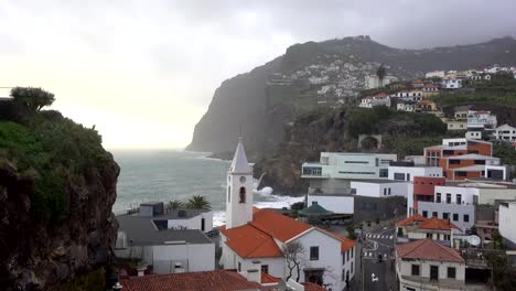 View-of-São-Sebastião-church-with-Cape-Girão,-in-Câmara-de-Lobos,-Madeira