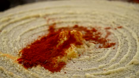 Closeup-of-frying-dosa-with-ghee,-chilli-and-coriander