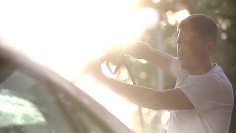 man-in-a-t-shirt-white-car-washes.-Slow-motion