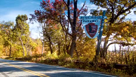 Car-Passing-Nostalgic-Blue-Ridge-Parkway-Sign-near-Asheville,-NC