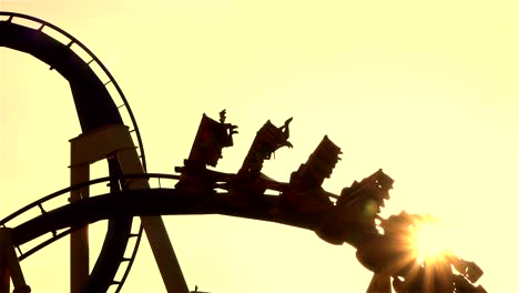 CLOSE-UP:-Friends-on-extreme-roller-coaster-ride-at-sunset