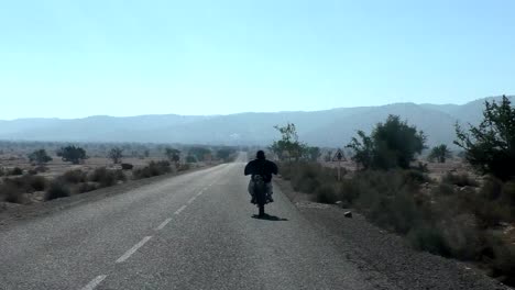 Man-riding-motorbike-in-Africa