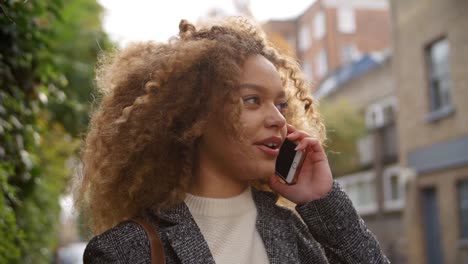 Stylish-Young-Woman-Making-Phone-Call-On-City-Street