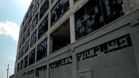 CLOSE-UP:-Broken-glass-on-the-windows-of-abandoned-Fisher-auto-factory,-Detroit