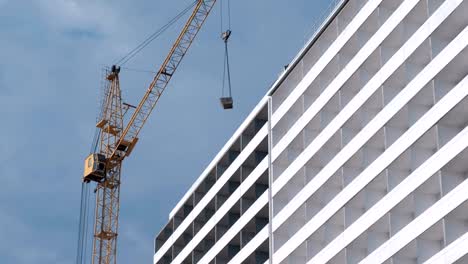 Construction-of-a-multi-storey-building.-House-and-construction-crane-on-sky-background.