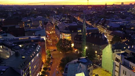 Aerial-view-of-red-roofs-in-old-city-at-night,-Munich,-Germany