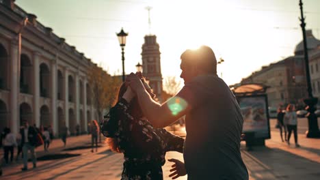 A-beautiful-couple-dancing-an-dance-with-elements-of-waltz,-leaks-of-sun.-Sunset-or-sunrise