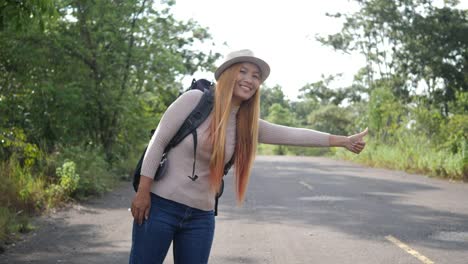 Traveler-woman-backpacker-hitchhiking-on-the-road-and-walking.
