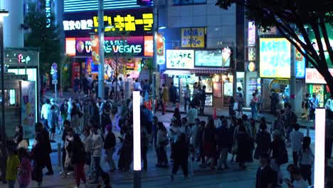 EDITORIAL-FOOTAGE:-Moving-High-Angle-Shot-of-the-Busy-Big-City-Street-with-Crowds-of-People-Walking-in-the-Evening.-Advertising-Billboards-Glowing.-Tokyo-at-Night.