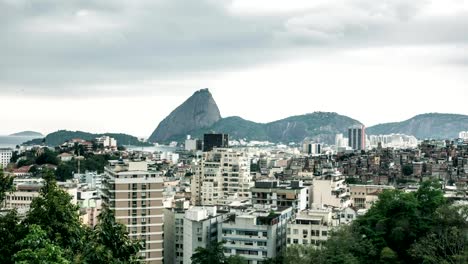 Sugarloaf-from-Santa-Teresa,-in-Rio-de-Janeiro,-with-cityscape-view-in-storm-sky-timelapse