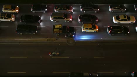 Time-lapse-of-traffic-in-Bogota,-Colombia,-cars-moving,-starting-and-stopping-at-highway-at-night,-shot-from-above