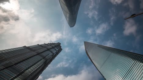 china-shanghai-summer-day-roof-top-downtown-buildings-sky-up-view-4k-time-lapse