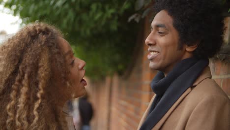 Stylish-Young-Couple-Talking-On-City-Street