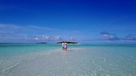 v03941-vuelo-drone-vista-aérea-de-Maldivas-playa-2-personas-pareja-hombre-mujer-amor-romántico-en-la-isla-de-paraíso-tropical-soleado-con-cielo-azul-aqua-agua-mar-4k