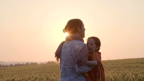 young-Asian-family-in-a-field-with-a-baby-1-year-on-hand,-the-concept-of-family-happiness,-beautiful-sunlight,-sunset,-slow-motion