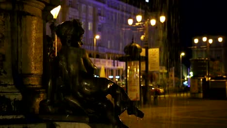 Statue-of-girl-sitting-on-the-edge-of-fountain-at-night,-romanticism-architecture