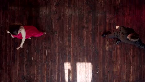 Tango-professionals.-Young-girl-in-red-dress-and-man-dancing-latin-in-studio.