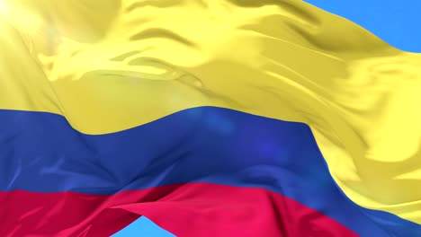Colombian-flag-waving-at-wind-in-slow-with-blue-sky,-loop