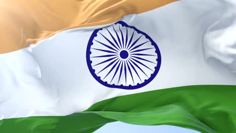 Indian-flag-waving-at-wind-in-slow-in-blue-sky,-loop