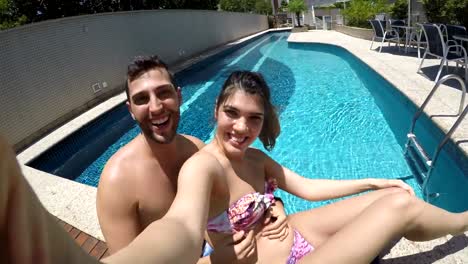 Young-Couple-taking-a-selfie-in-the-Swimming-Pool