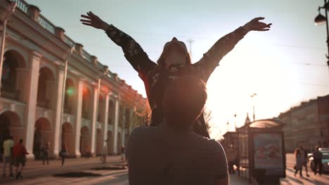 Young-couple,-male-and-female,-dancing-at-sunset-street,-they-turning-and-rotating