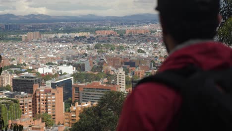 Man-looking-at-Bogota-from-the-mountain