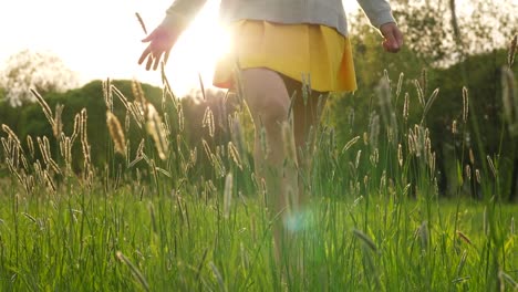 Silhuette-woman-figure-touching-hand-tall-grass