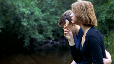 Enamored-teenagers-sit-in-the-background-of-nature-and-talk-with-each-other.