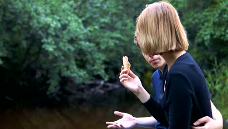 Enamored-teenagers-sit-in-the-background-of-nature-and-talk-with-each-other.