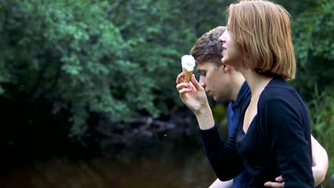 Enamored-teenagers-sit-in-the-background-of-nature-and-talk-with-each-other.