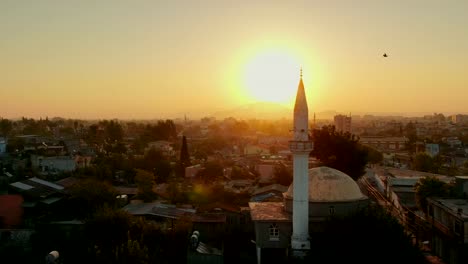 Flight-above-Muslim-town-with-mosque-minaret-and-residential-buildings.