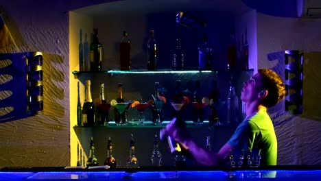 Professional-bartender-making-cool,-amazing-tricks-three-shakers,-juggling-standing-behind-the-bar,-catching,-throwing-up,-slow-motion