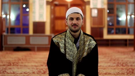 muslim-reverend-is-sitting-and-looking-at-camera